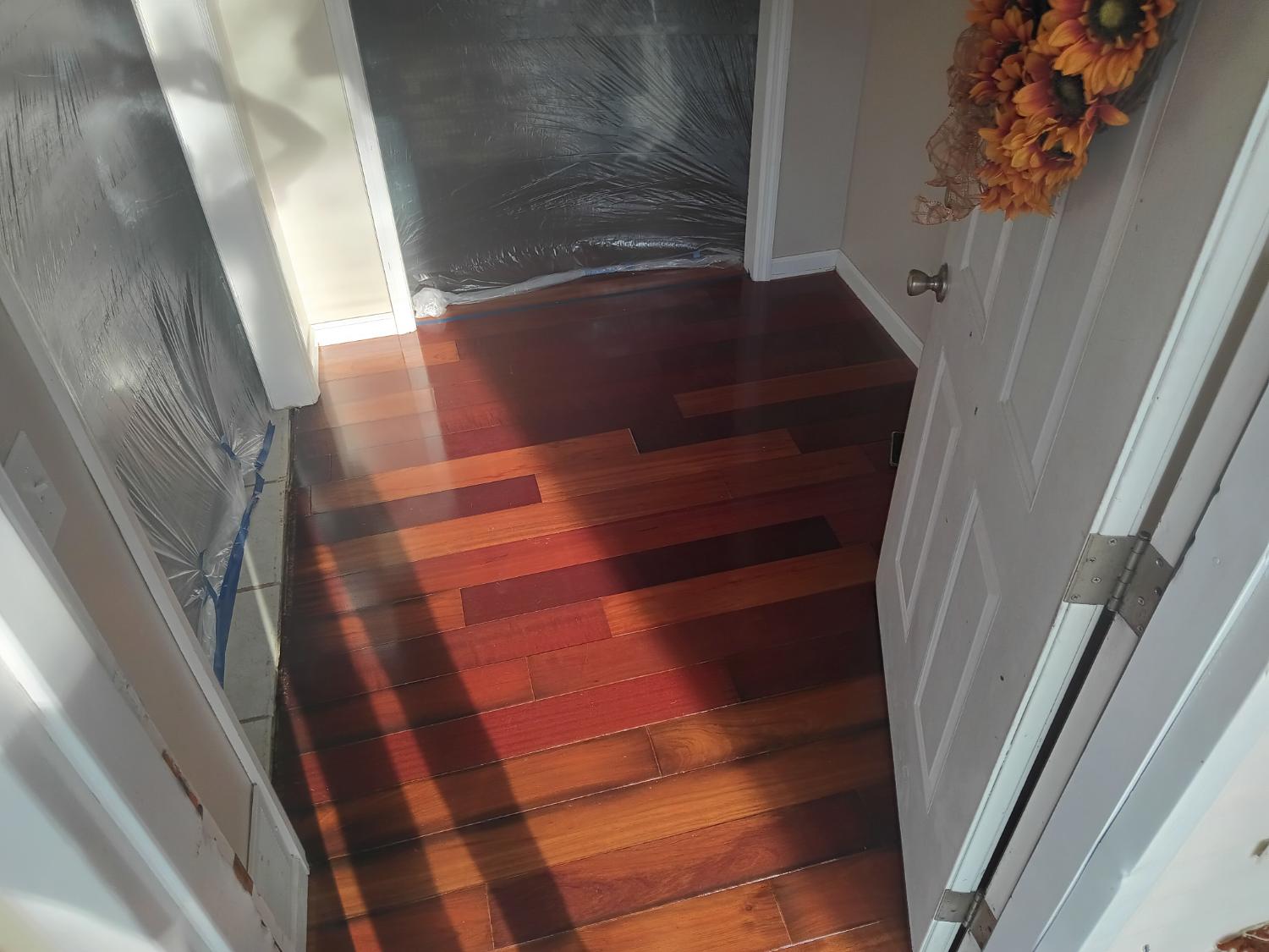 Hallway with rich multi-tone wood flooring