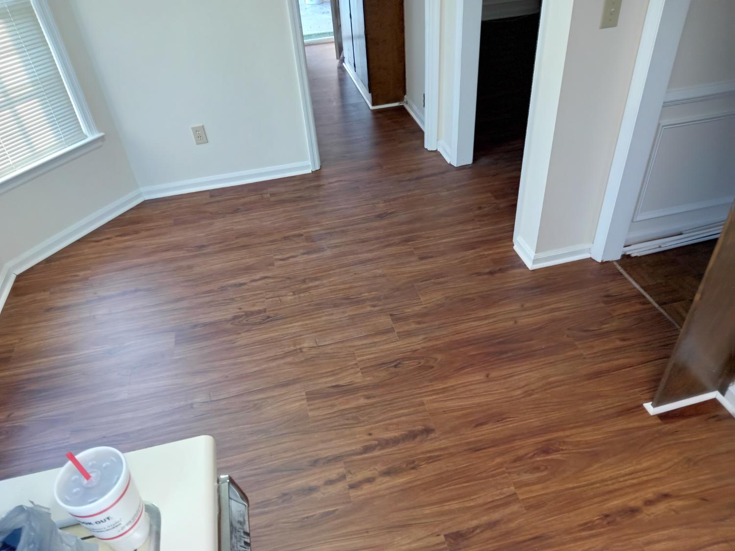 Open rooms with rich brown LVP