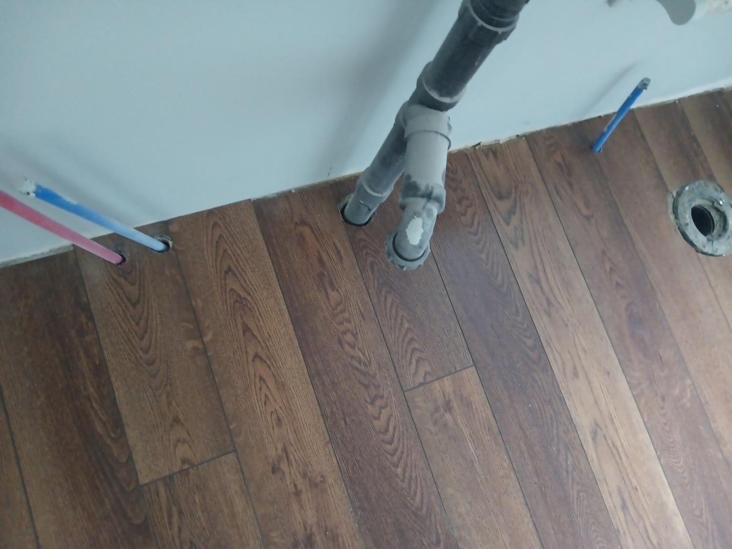 Dark LVP around plumbing penetrations
