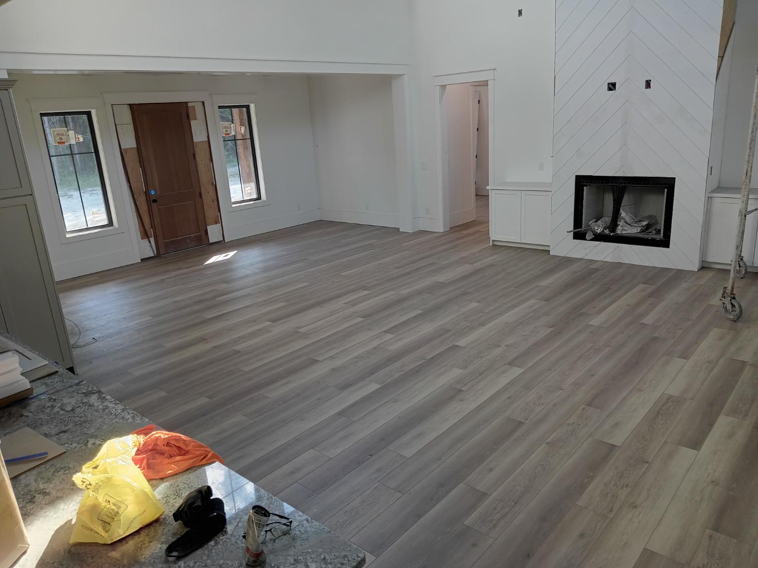 Living room with fireplace and light LVP flooring