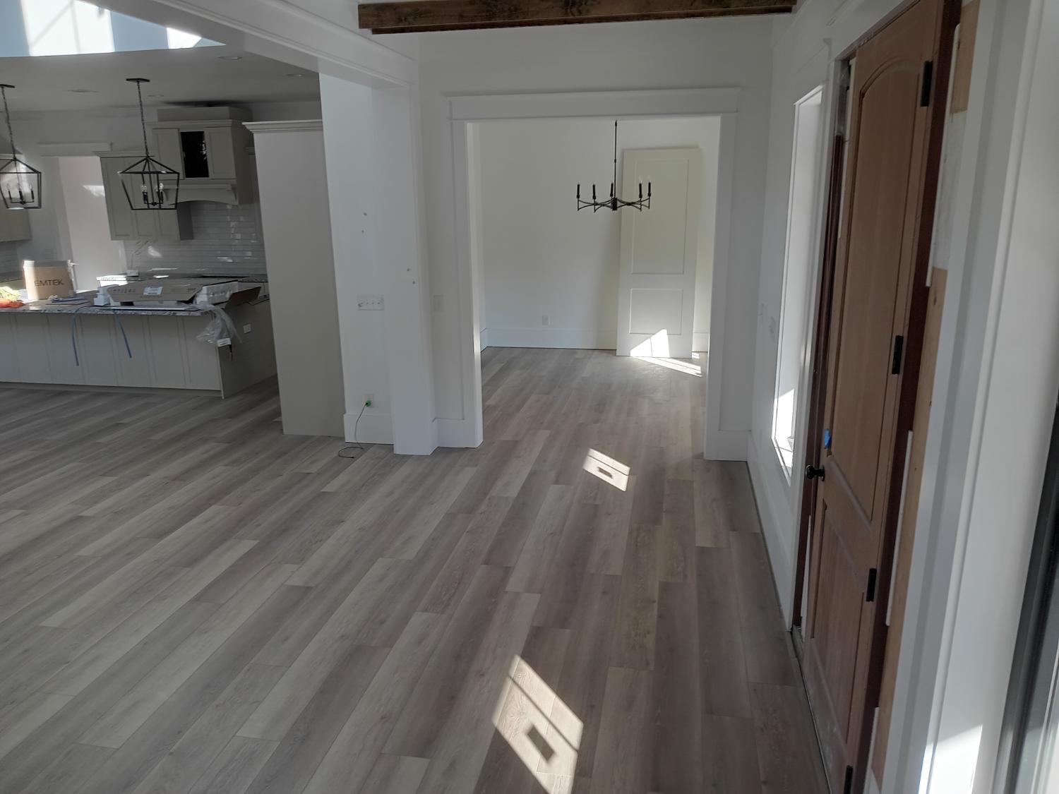 Hallway and living area with continuous LVP install