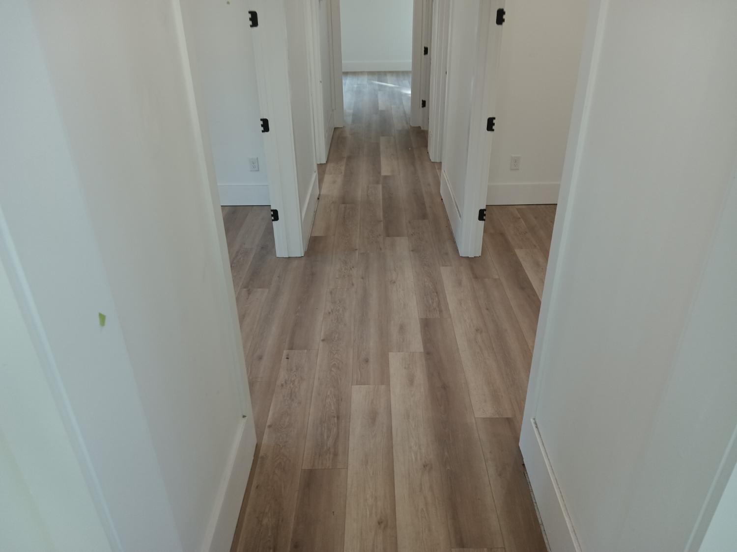 Hallway with LVP flowing into bedrooms