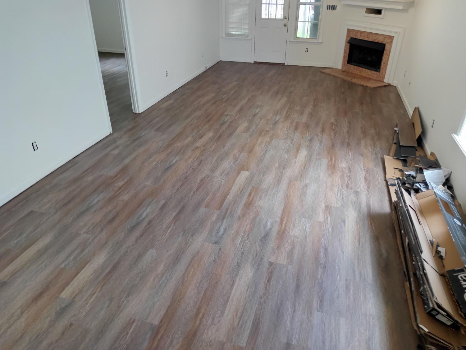 Living room install with fireplace and LVP