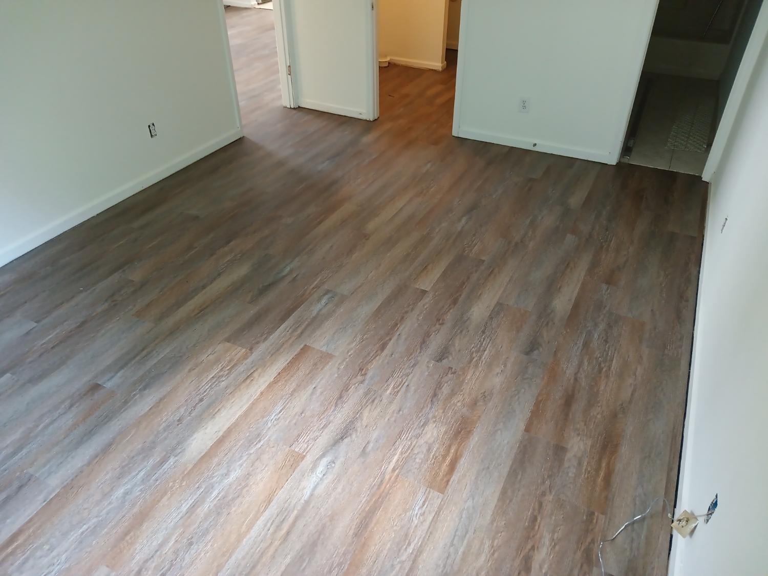 Open floor plan with medium gray LVP